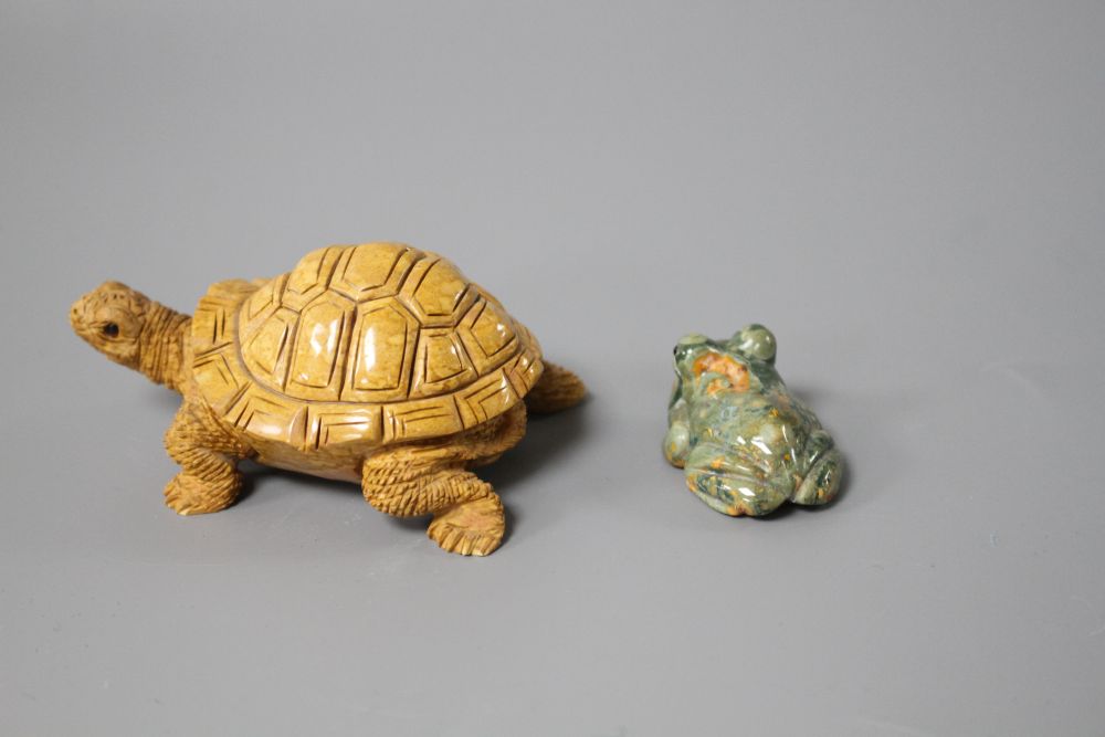 A carved fossil stone tortoise, 8cm and a carved Rhiolite carving of a frog, 4cm